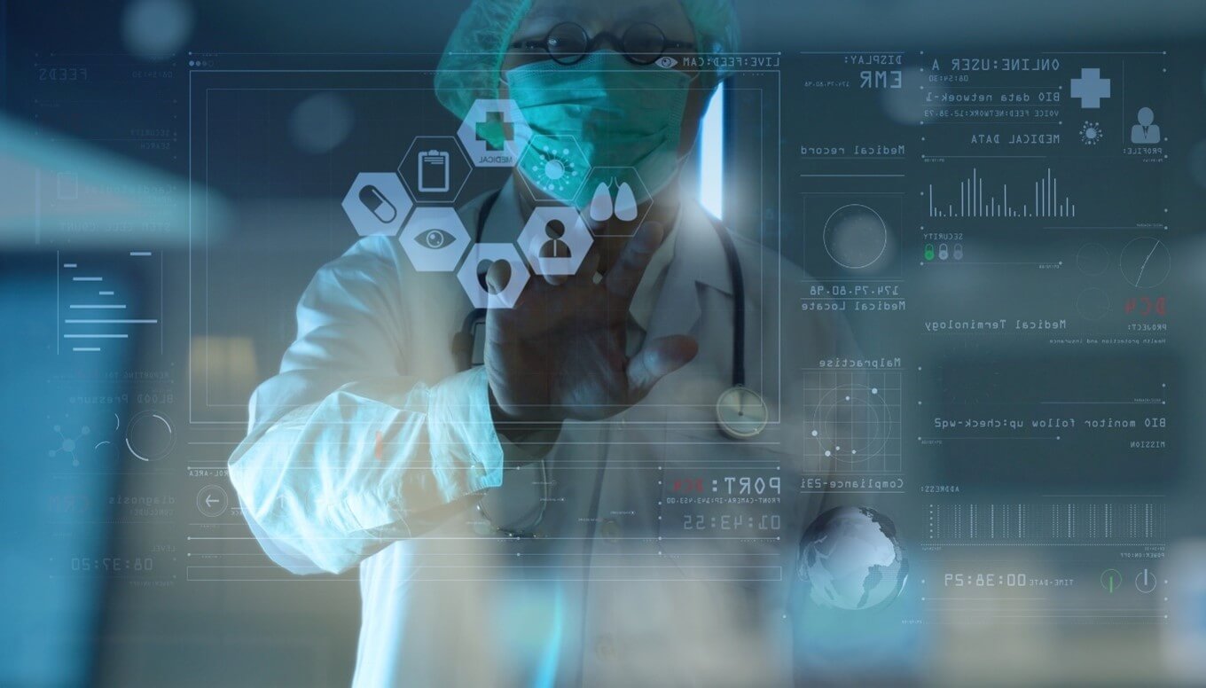 Image of a medical expert using a touch screen to select data points. He is wearing glasses and a facemask.
